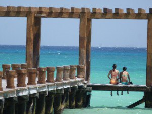Couple sitting on the pier in Playa del Carmen