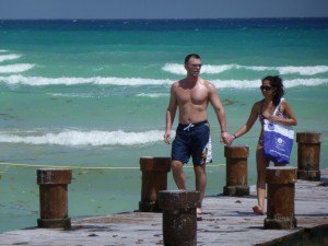 Couple holding hands on the pier on Playa del Carmen