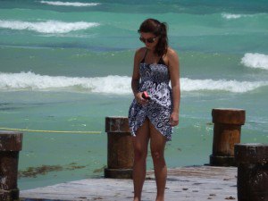 Beautiful girl walking on the pier in Playa del Carmen